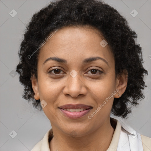 Joyful black adult female with medium  brown hair and brown eyes