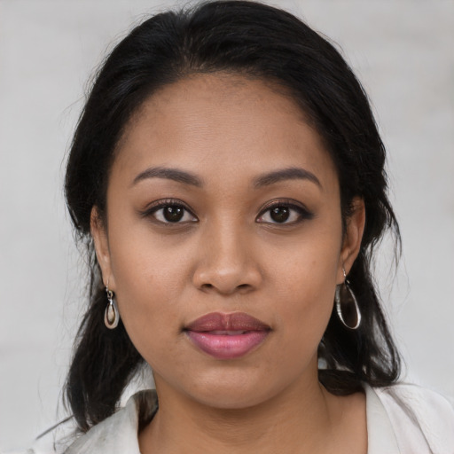 Joyful latino young-adult female with medium  brown hair and brown eyes