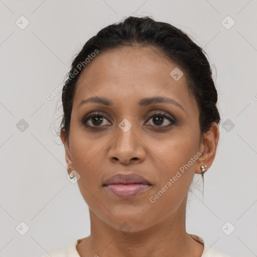 Joyful latino adult female with short  brown hair and brown eyes