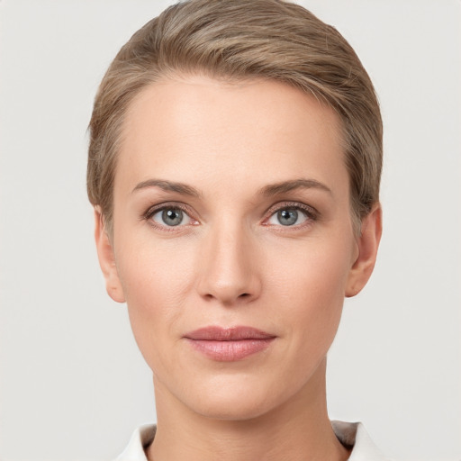 Joyful white young-adult female with short  brown hair and grey eyes