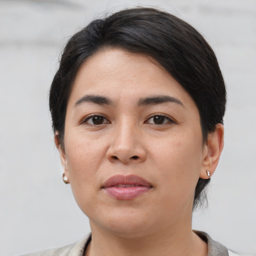 Joyful latino young-adult female with medium  black hair and brown eyes