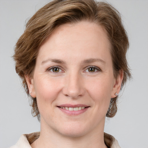 Joyful white young-adult female with medium  brown hair and grey eyes