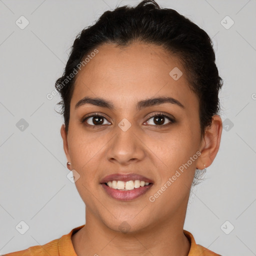 Joyful latino young-adult female with short  brown hair and brown eyes