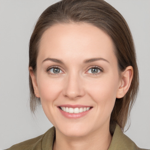 Joyful white young-adult female with medium  brown hair and grey eyes