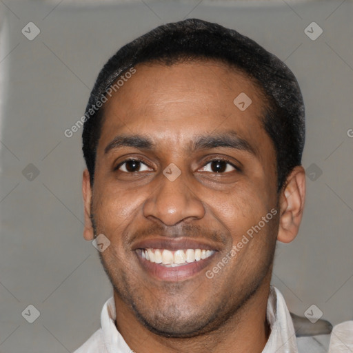 Joyful latino adult male with short  black hair and brown eyes