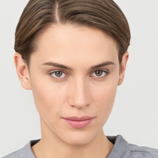 Joyful white young-adult female with short  brown hair and grey eyes