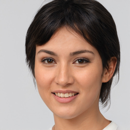 Joyful asian young-adult female with medium  brown hair and brown eyes