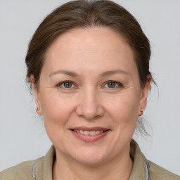 Joyful white adult female with medium  brown hair and grey eyes