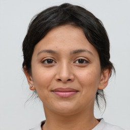 Joyful latino young-adult female with medium  brown hair and brown eyes