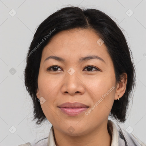 Joyful asian adult female with medium  brown hair and brown eyes