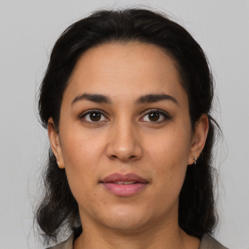 Joyful latino young-adult female with medium  brown hair and brown eyes