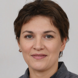 Joyful white adult female with short  brown hair and brown eyes