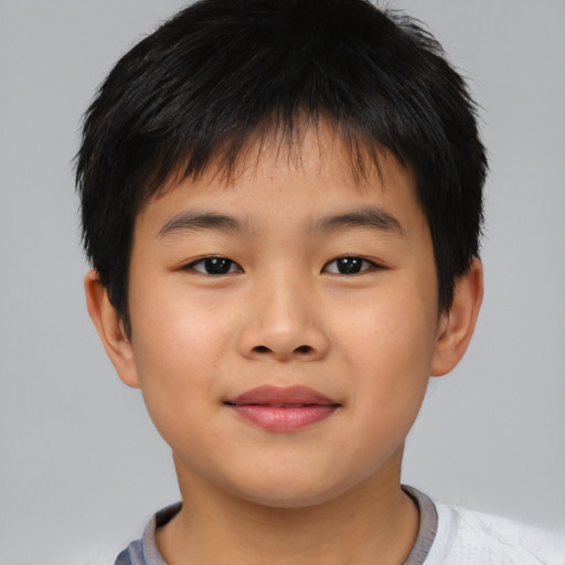 Joyful asian child male with short  brown hair and brown eyes