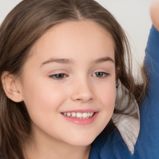 Joyful white child female with long  brown hair and brown eyes