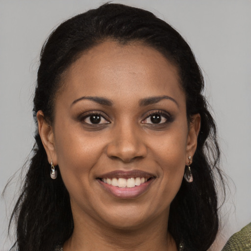 Joyful black young-adult female with medium  brown hair and brown eyes