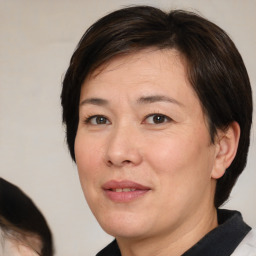 Joyful white adult female with medium  brown hair and brown eyes