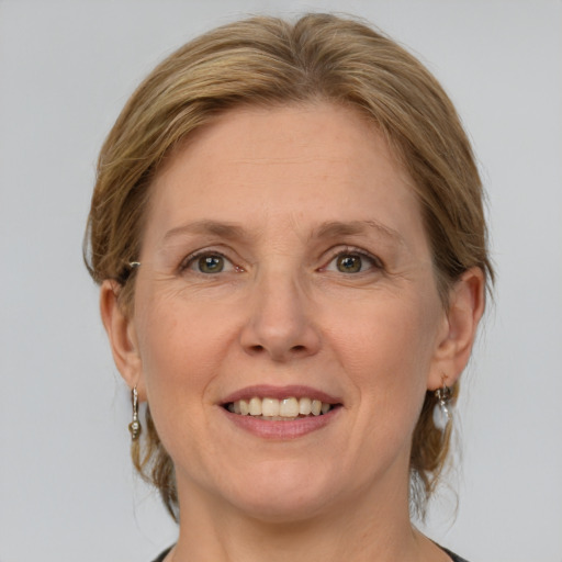 Joyful white adult female with medium  brown hair and grey eyes