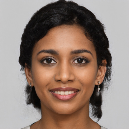 Joyful black young-adult female with medium  black hair and brown eyes
