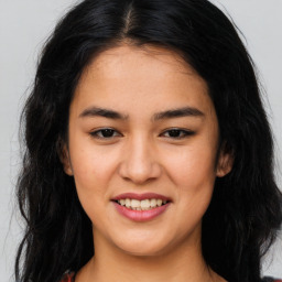 Joyful asian young-adult female with long  brown hair and brown eyes