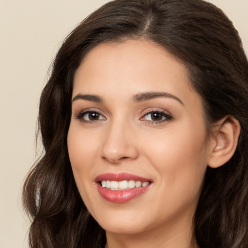 Joyful white young-adult female with long  brown hair and brown eyes