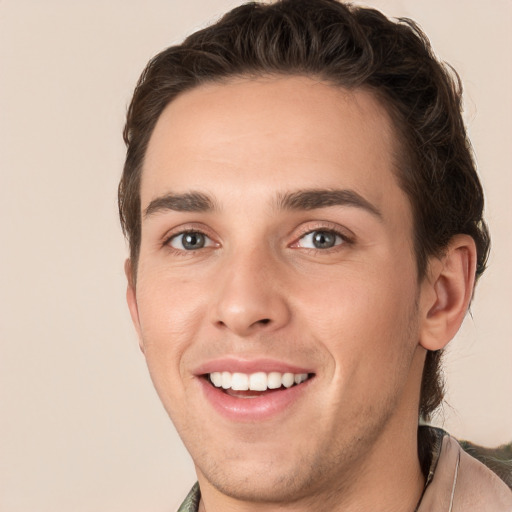 Joyful white young-adult male with short  brown hair and green eyes