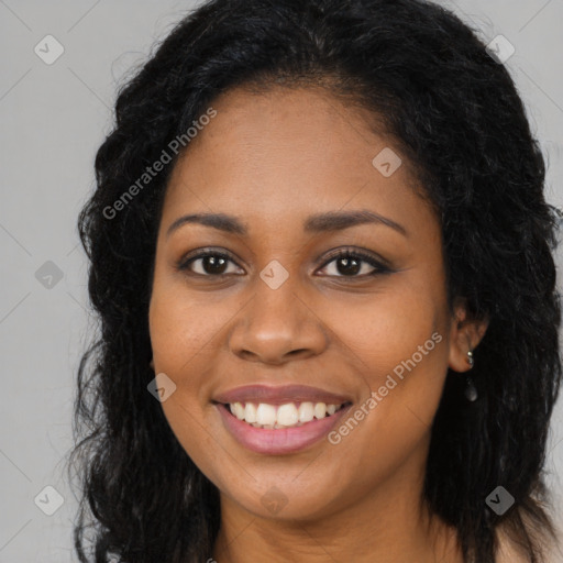 Joyful black young-adult female with long  brown hair and brown eyes