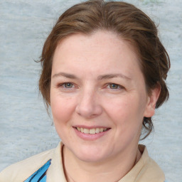 Joyful white adult female with medium  brown hair and blue eyes