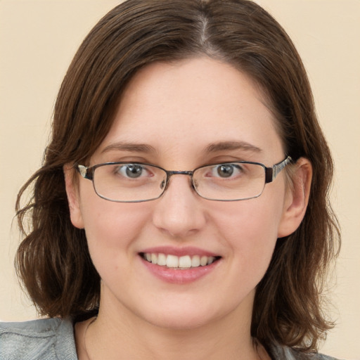 Joyful white young-adult female with medium  brown hair and blue eyes