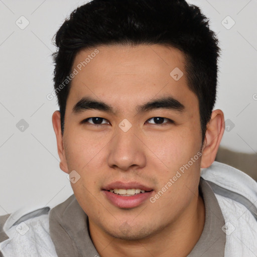 Joyful asian young-adult male with short  black hair and brown eyes