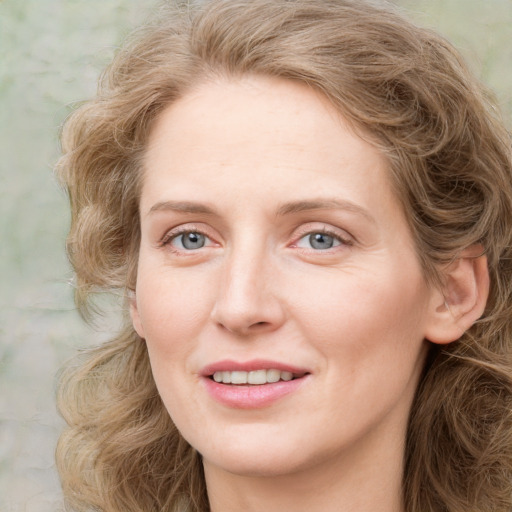 Joyful white young-adult female with medium  brown hair and green eyes