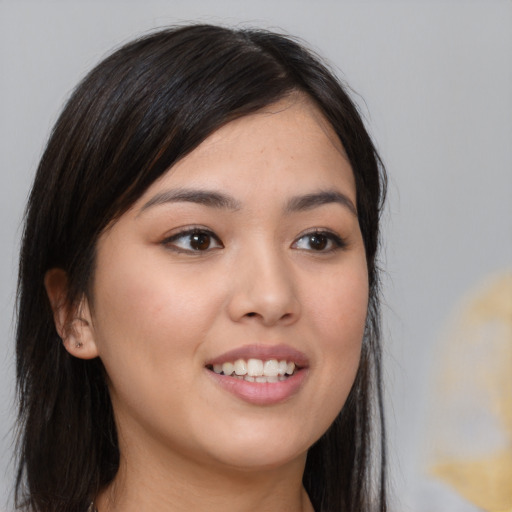 Joyful asian young-adult female with long  brown hair and brown eyes