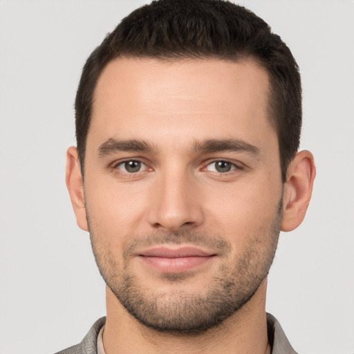 Joyful white young-adult male with short  brown hair and brown eyes