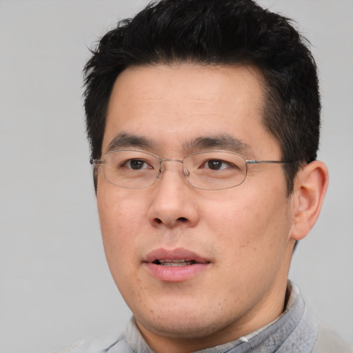 Neutral asian adult male with short  brown hair and brown eyes