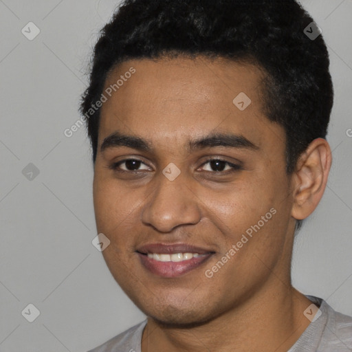 Joyful black young-adult male with short  black hair and brown eyes