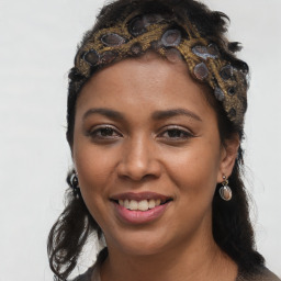 Joyful black young-adult female with long  brown hair and brown eyes