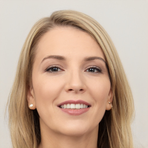 Joyful white young-adult female with long  brown hair and brown eyes