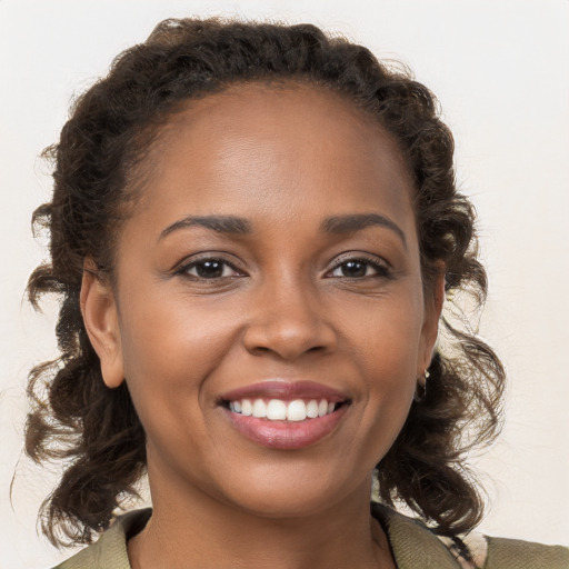 Joyful black young-adult female with medium  brown hair and brown eyes