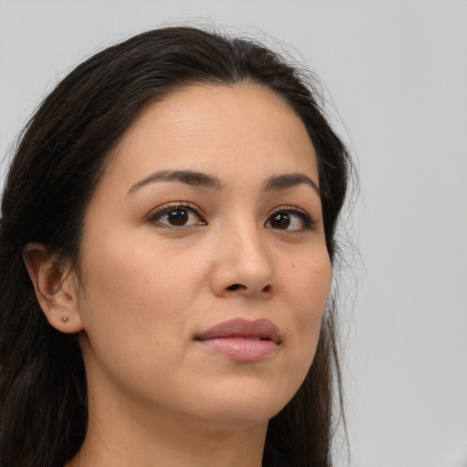 Joyful latino young-adult female with long  brown hair and brown eyes