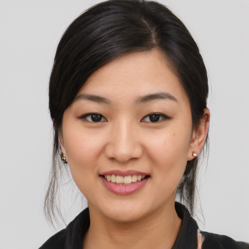 Joyful asian young-adult female with medium  brown hair and brown eyes