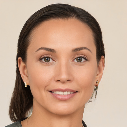 Joyful white young-adult female with medium  brown hair and brown eyes