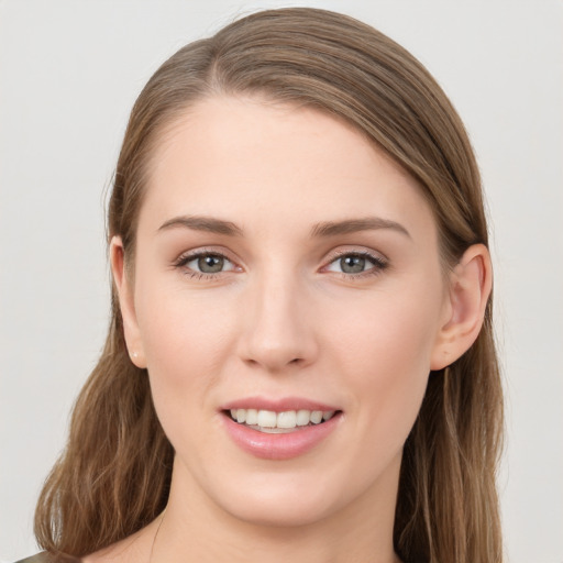 Joyful white young-adult female with long  brown hair and grey eyes