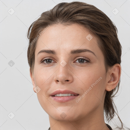 Joyful white young-adult female with short  brown hair and grey eyes