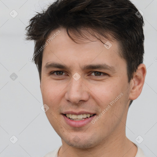 Joyful white young-adult male with short  brown hair and brown eyes