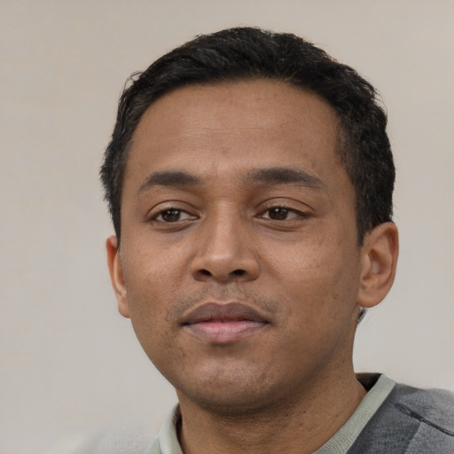 Neutral latino young-adult male with short  black hair and brown eyes