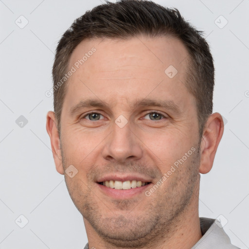 Joyful white adult male with short  brown hair and brown eyes