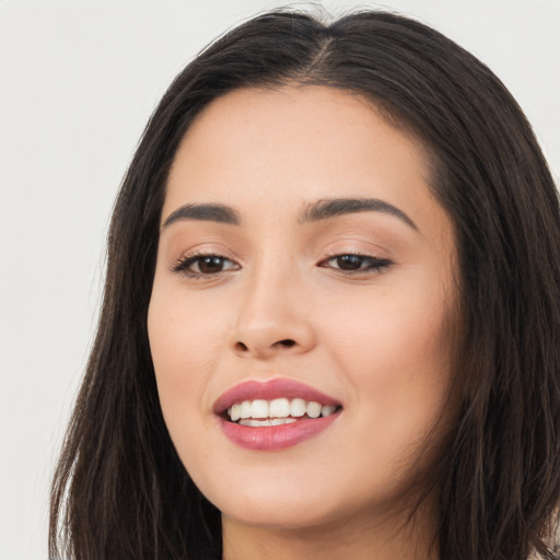 Joyful asian young-adult female with long  brown hair and brown eyes