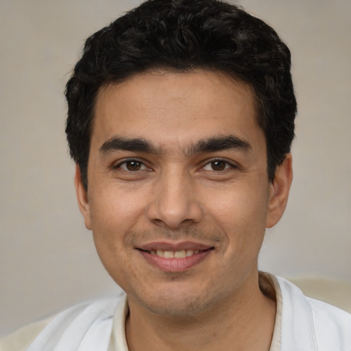 Joyful white young-adult male with short  black hair and brown eyes