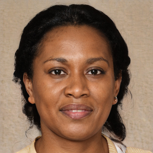 Joyful black adult female with medium  black hair and brown eyes