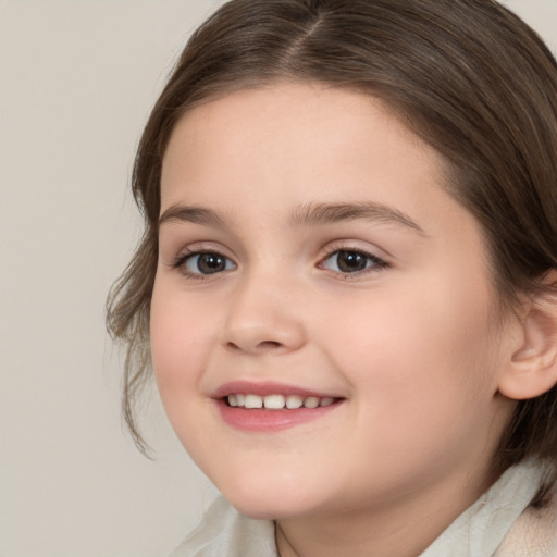 Joyful white child female with medium  brown hair and brown eyes