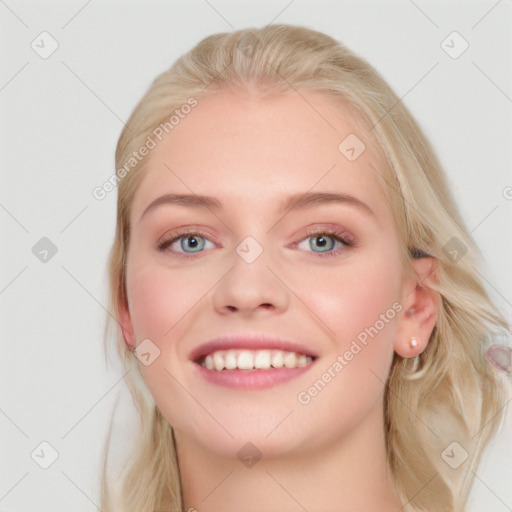 Joyful white young-adult female with long  brown hair and blue eyes